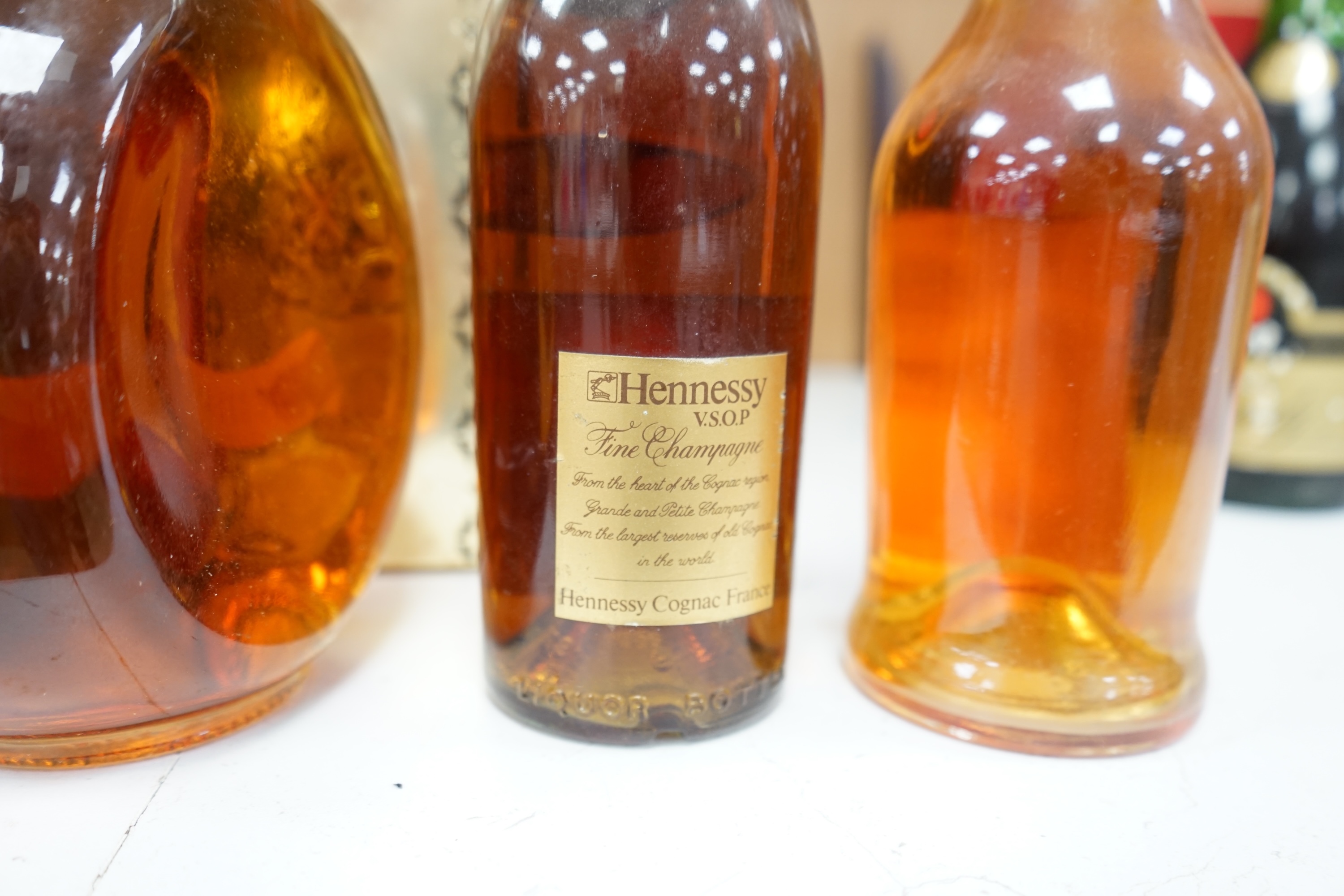 Four bottles of various alcohols comprising a bottle of 50cl Hennessey Fine Champagne Cognac, Planty Fine Cognac, Dimple Scotch Whisky and Glocken Apfel. Condition - fair, storage history unknown